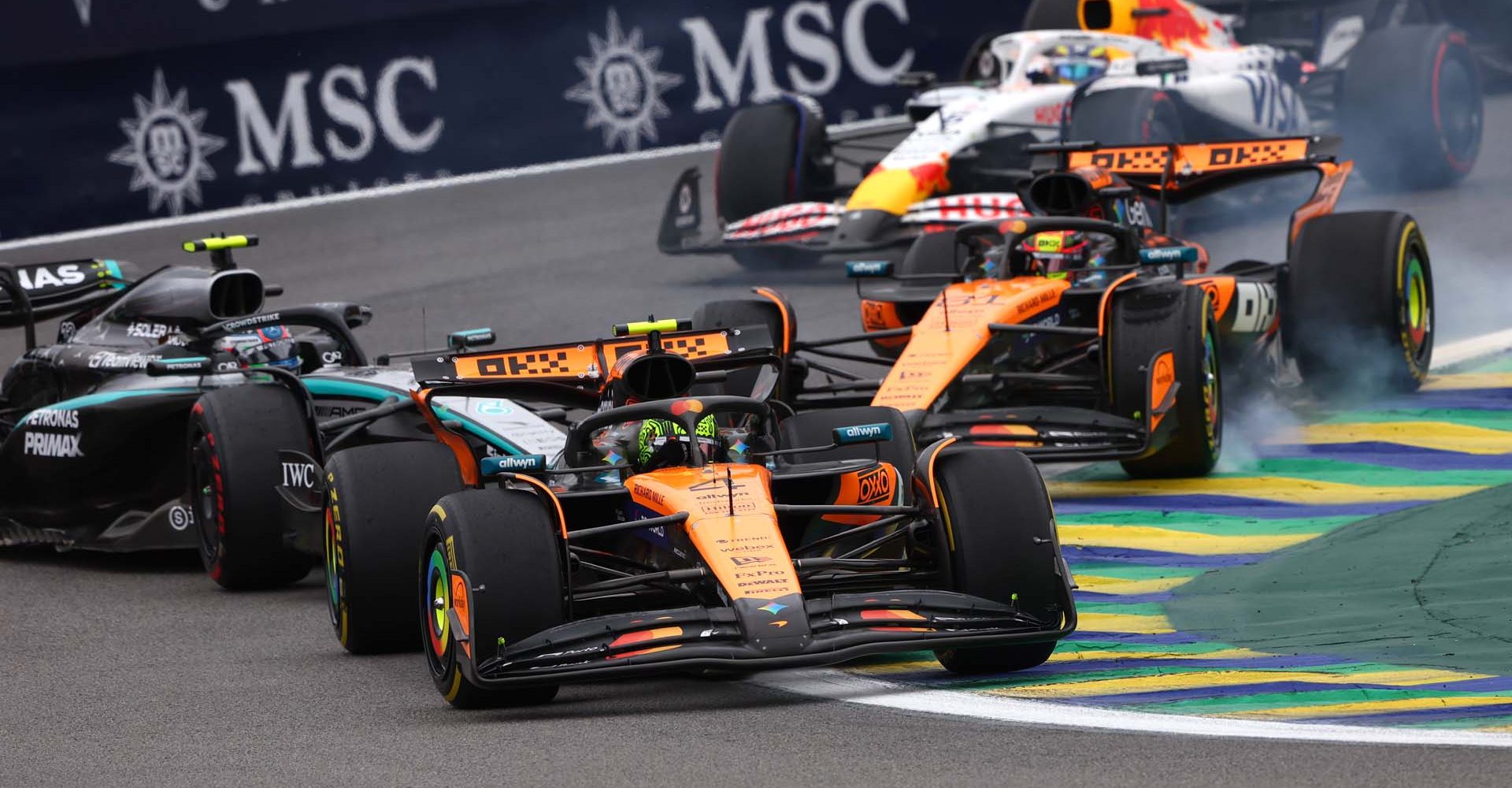 SAO PAULO, BRAZIL - NOVEMBER 09: Lando Norris of Great Britain driving the (4) McLaren MCL39 Mercedes leads as Oscar Piastri of Australia driving the (81) McLaren MCL39 Mercedes and Andrea Kimi Antonelli of Italy driving the (12) Mercedes AMG Petronas F1 Team W16 make contact during the F1 Grand Prix of Brazil at Autodromo Jose Carlos Pace on November 09, 2025 in Sao Paulo, Brazil. (Photo by Andy Hone/LAT Images)