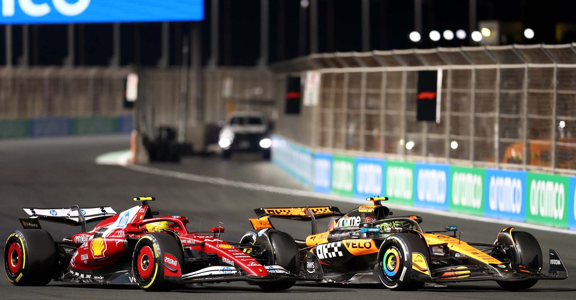 JEDDAH, SAUDI ARABIA - APRIL 20: Lando Norris of Great Britain driving the (4) McLaren MCL39 Mercedes and Lewis Hamilton of Great Britain driving the (44) Scuderia Ferrari SF-25 battle for track position on track during the F1 Grand Prix of Saudi Arabia at Jeddah Corniche Circuit on April 20, 2025 in Jeddah, Saudi Arabia. (Photo by Zak Mauger/LAT Images)