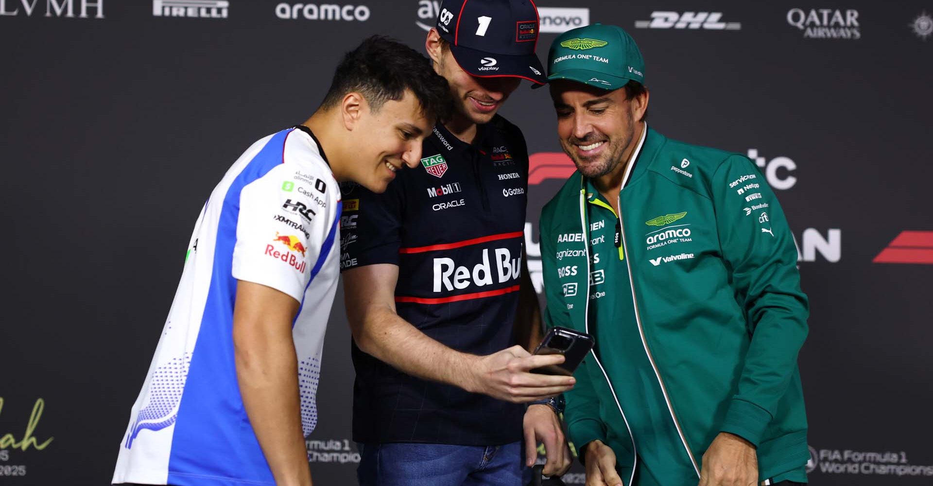 JEDDAH, SAUDI ARABIA - APRIL 17: Max Verstappen of the Netherlands and Oracle Red Bull Racing shows Isack Hadjar of France and Visa Cash App Racing Bulls and Fernando Alonso of Spain and Aston Martin F1 Team something on his phone ahead of the Drivers Press Conference during previews ahead of the F1 Grand Prix of Saudi Arabia at Jeddah Corniche Circuit on April 17, 2025 in Jeddah, Saudi Arabia. (Photo by Clive Rose/Getty Images) // Getty Images / Red Bull Content Pool // SI202504171395 // Usage for editorial use only //