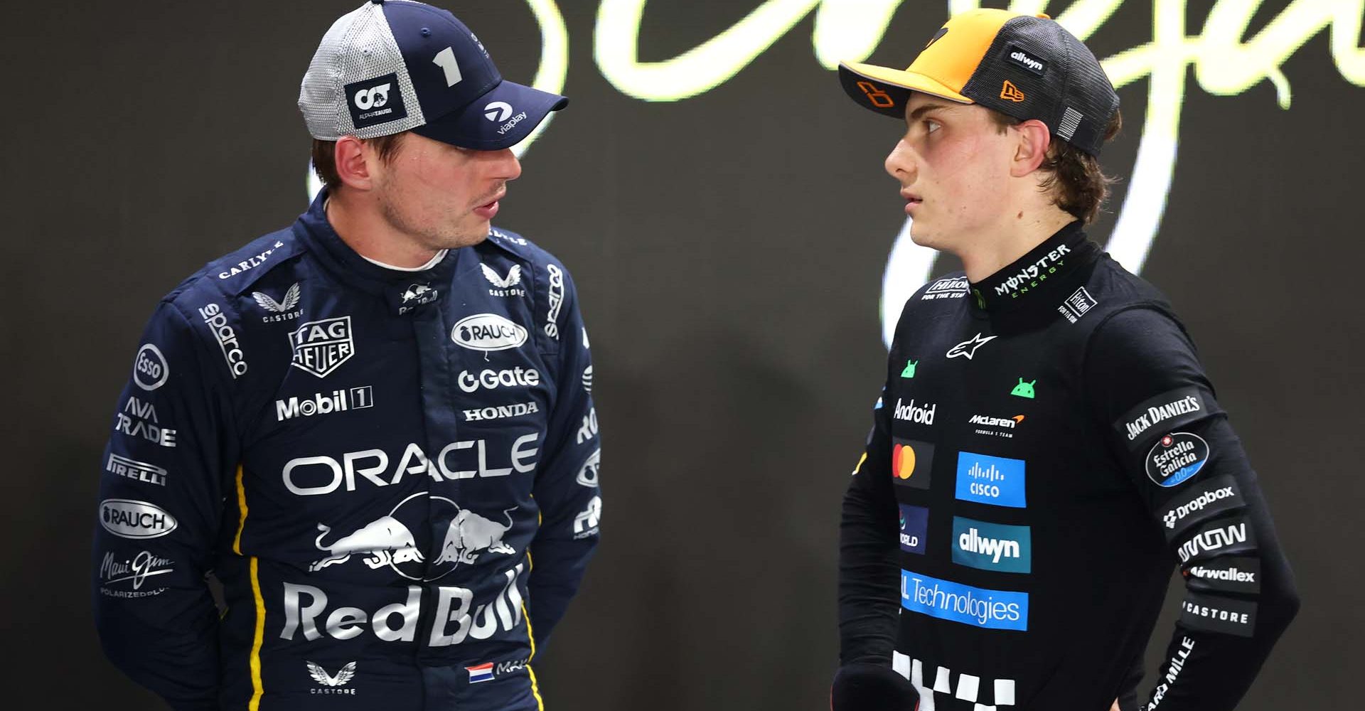 SINGAPORE, SINGAPORE - OCTOBER 04: Second placed qualifier Max Verstappen of the Netherlands and Oracle Red Bull Racing and Third placed qualifier Oscar Piastri of Australia and McLaren talk in parc ferme during qualifying ahead of the F1 Grand Prix of Singapore at Marina Bay Street Circuit on October 04, 2025 in Singapore, Singapore. (Photo by Zak Mauger/LAT Images)
