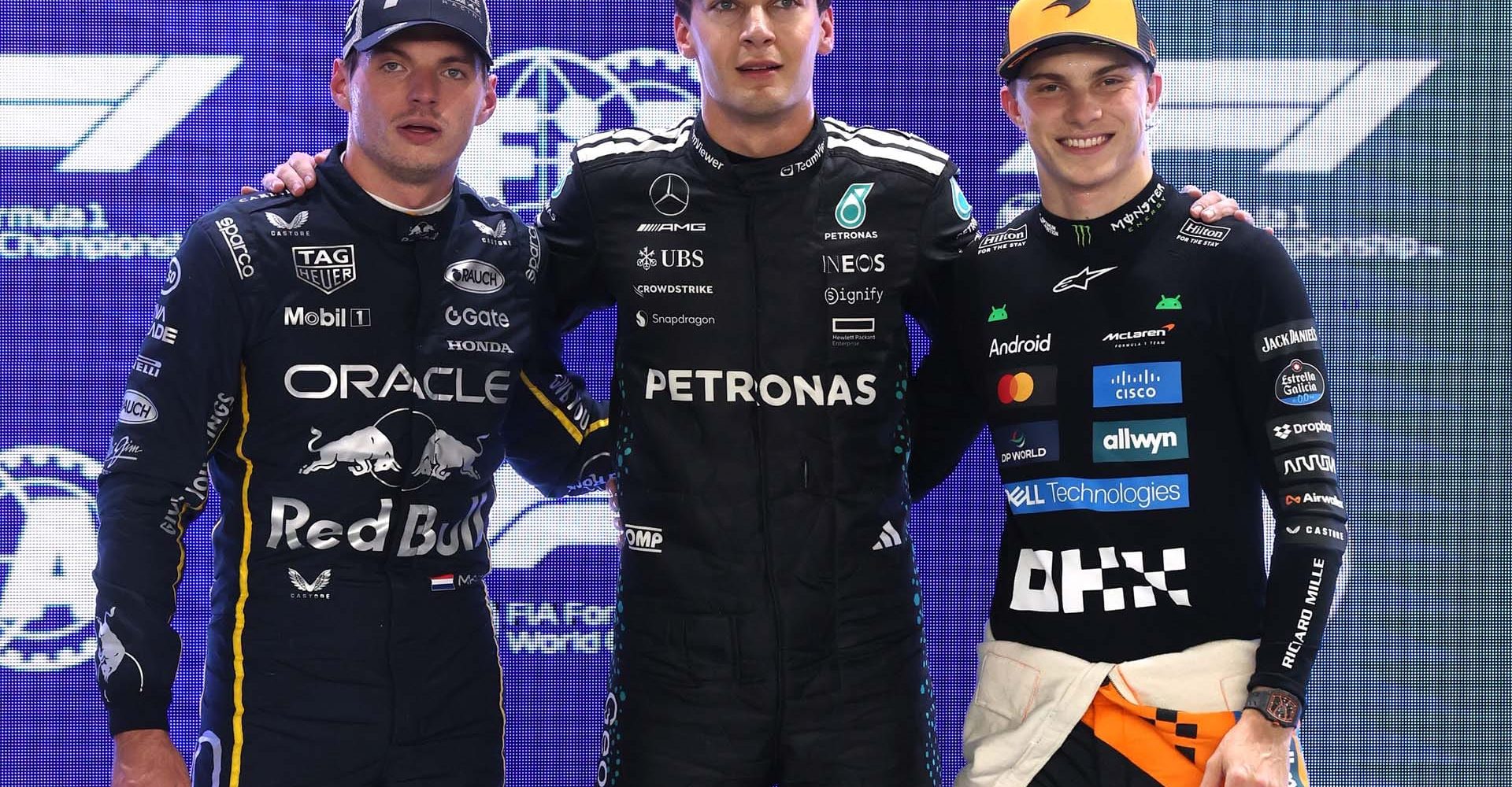 SINGAPORE, SINGAPORE - OCTOBER 04: Pole position qualifier George Russell of Great Britain and Mercedes AMG Petronas F1 Team Second placed qualifier Max Verstappen of the Netherlands and Oracle Red Bull Racing and Third placed qualifier Oscar Piastri of Australia and McLaren look on during qualifying ahead of the F1 Grand Prix of Singapore at Marina Bay Street Circuit on October 04, 2025 in Singapore, Singapore. (Photo by Steven Tee/LAT Images)