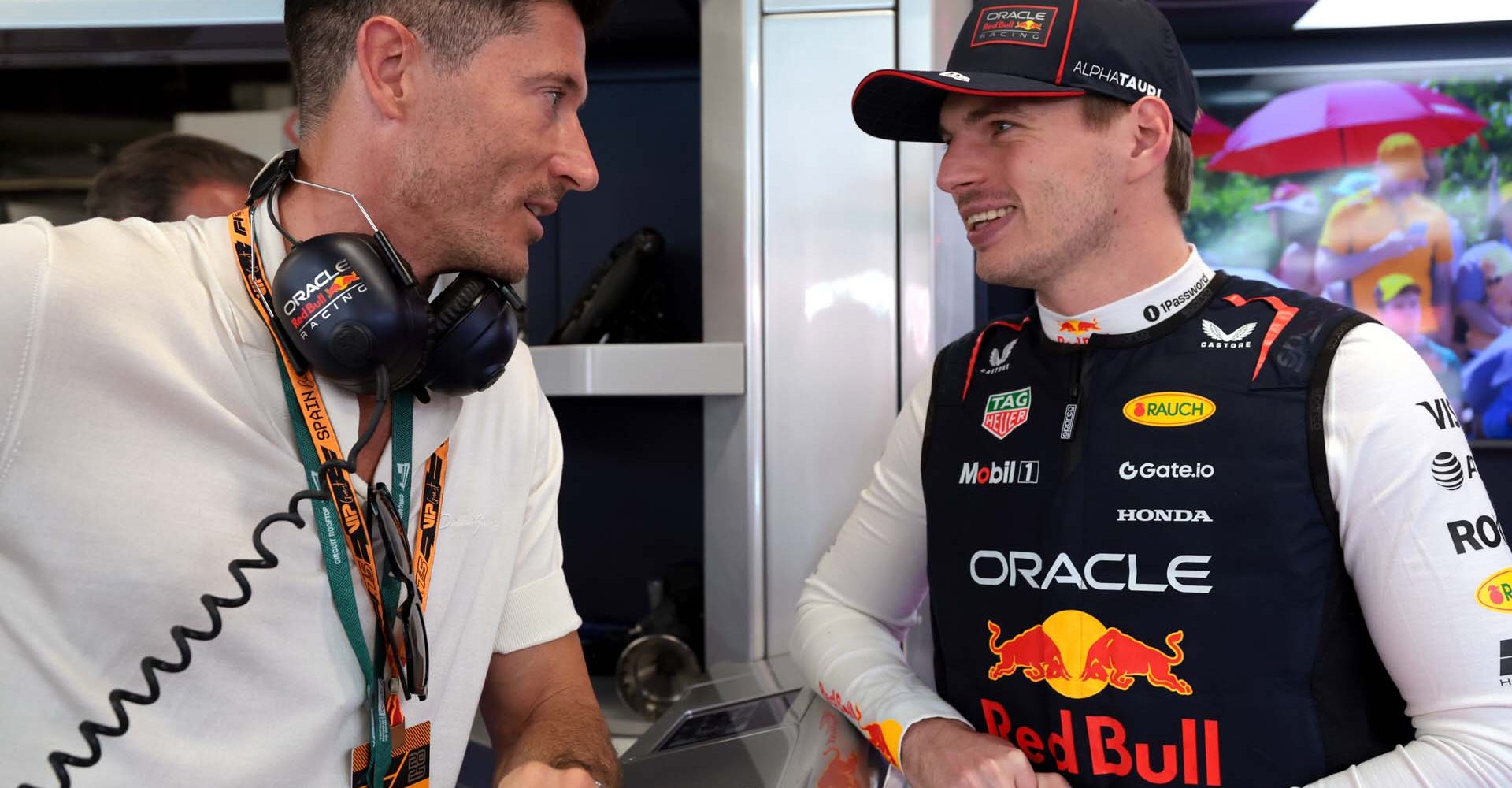 BARCELONA, SPAIN - MAY 31: Robert Lewandowski talks with Max Verstappen of the Netherlands and Oracle Red Bull Racing in the garage during qualifying ahead of the F1 Grand Prix of Spain at Circuit de Barcelona-Catalunya on May 31, 2025 in Barcelona, Spain. (Photo by Mark Thompson/Getty Images) // Getty Images / Red Bull Content Pool // SI202505310469 // Usage for editorial use only //