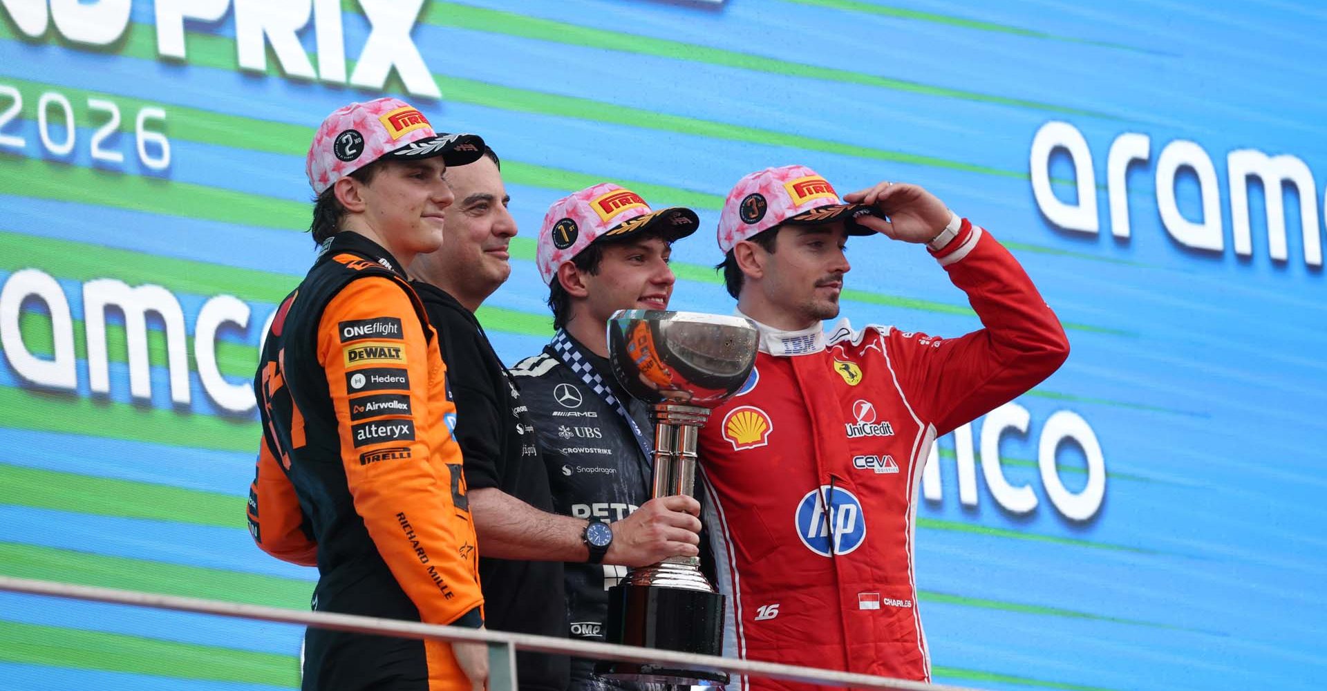 SUZUKA, JAPAN - MARCH 29: Race winner Andrea Kimi Antonelli of Italy and Mercedes AMG Petronas F1 Team Second placed Oscar Piastri of Australia and McLaren Third placed Charles Leclerc of Monaco and Scuderia Ferrari and Giacomo Tortora, Director of Car Design at Mercedes AMG Petronas F1 Team on the podium during the F1 Grand Prix of Japan at Suzuka Circuit on March 29, 2026 in Suzuka, Japan. (Photo by Lars Baron/LAT Images)
