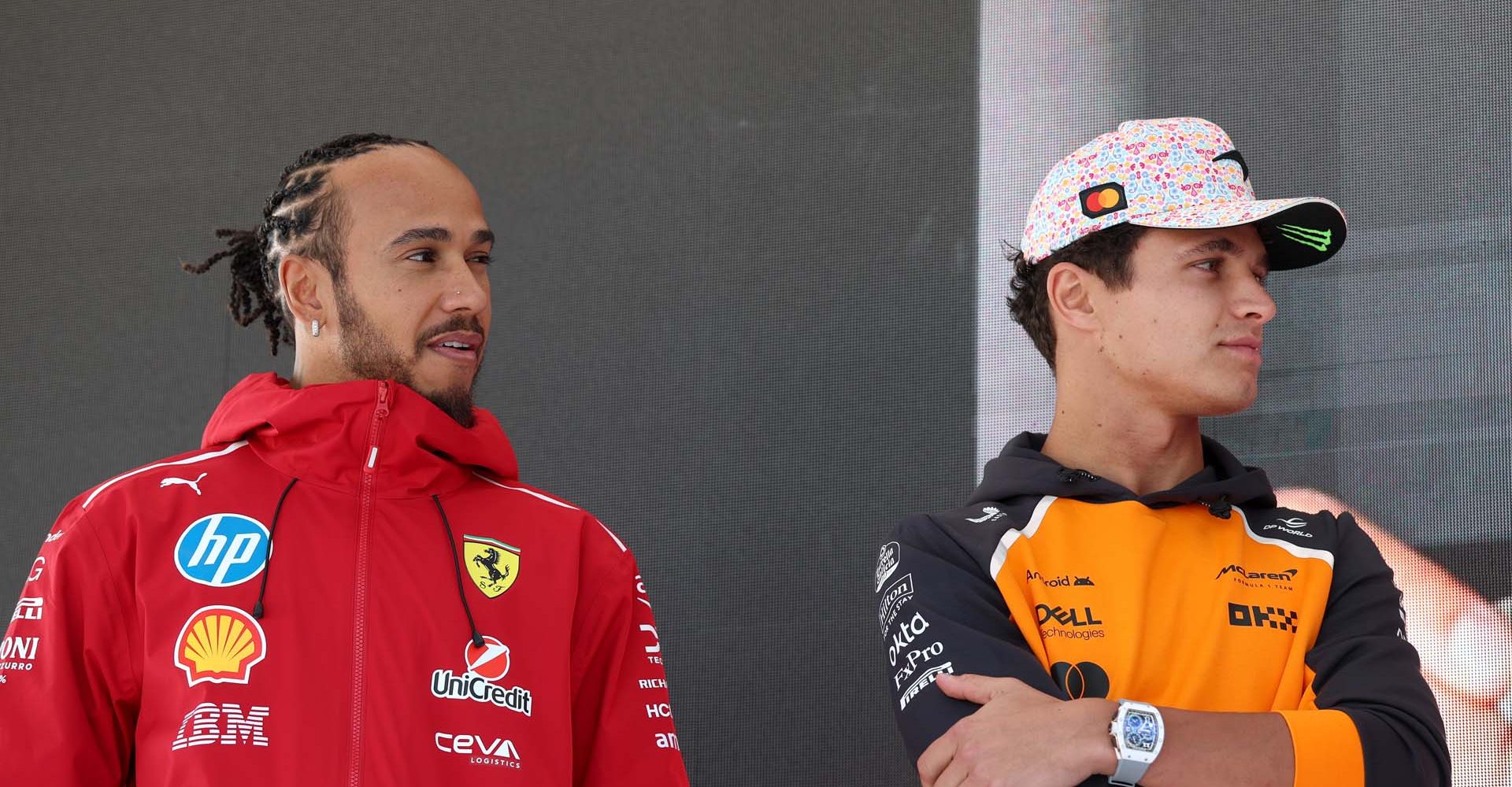 MEXICO CITY, MEXICO - OCTOBER 24: Lewis Hamilton of Great Britain and Scuderia Ferrari and Lando Norris of Great Britain and McLaren look on from the fan stage prior to practice ahead of the F1 Grand Prix of Mexico at Autodromo Hermanos Rodriguez on October 24, 2025 in Mexico City, Mexico. (Photo by Steven Tee/LAT Images)