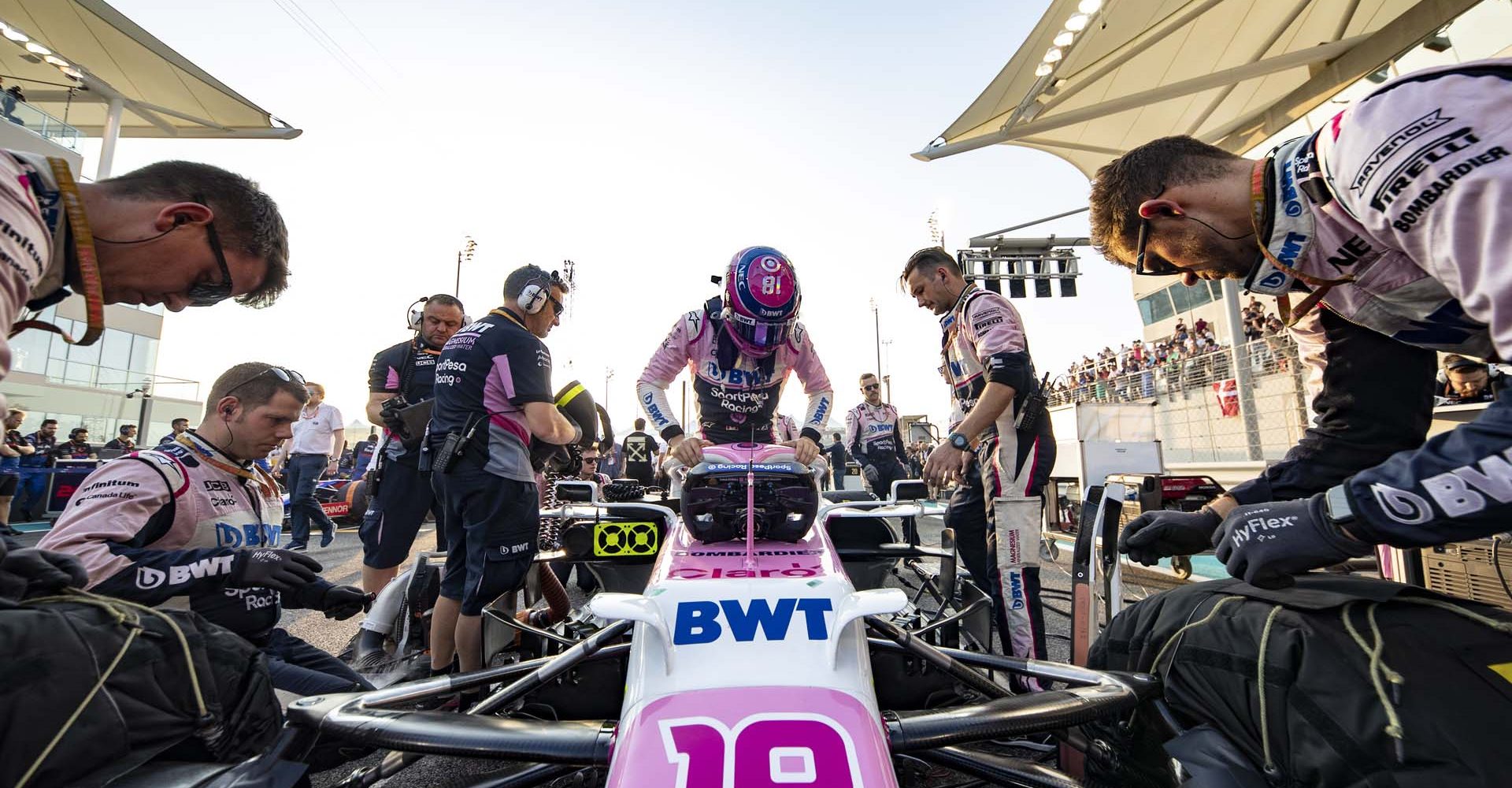 Lance Stroll, Racing Point RP19 gets into his car on the grid.