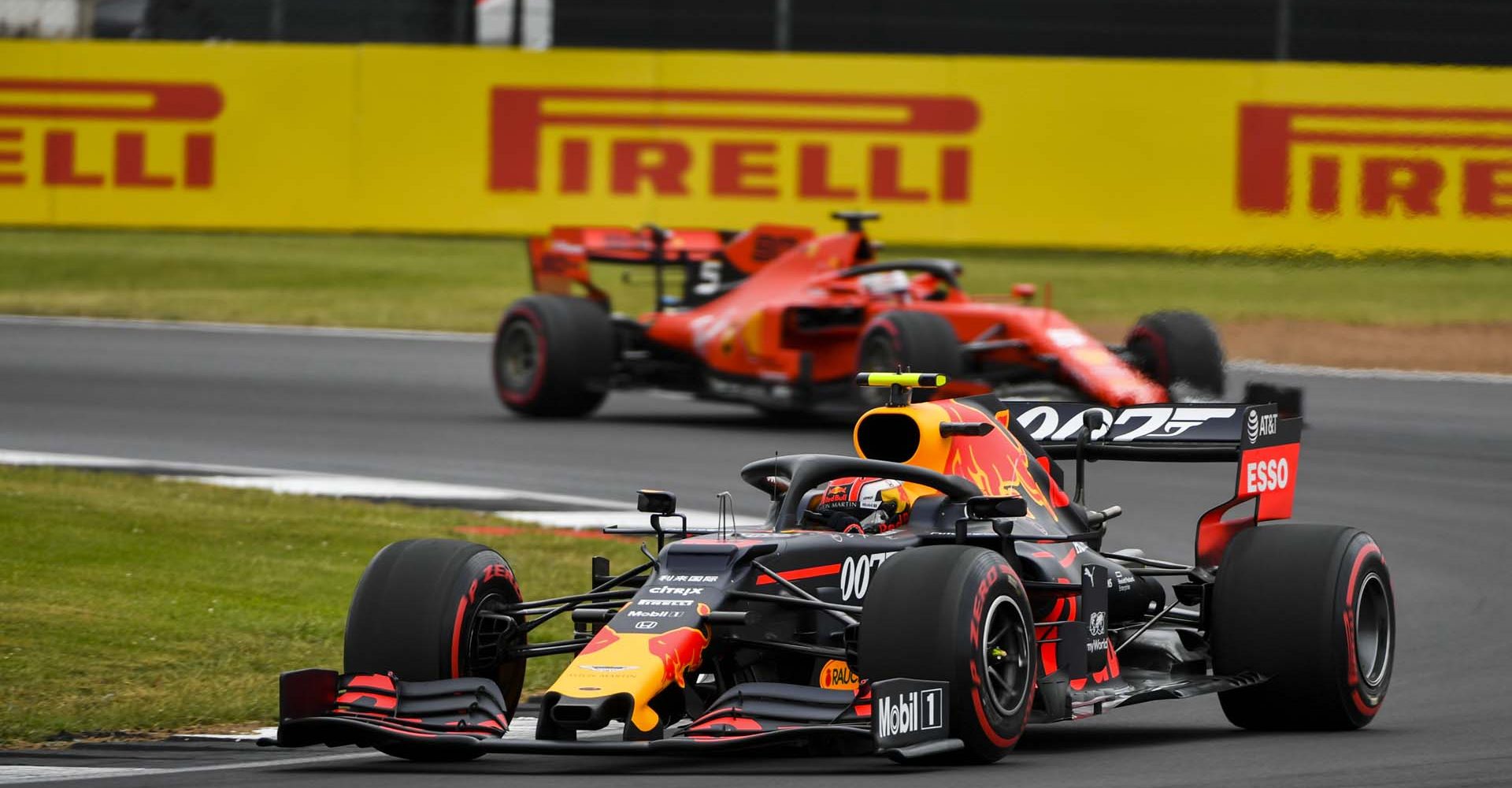 SILVERSTONE, UNITED KINGDOM - JULY 13: Pierre Gasly, Red Bull Racing RB15, leads Sebastian Vettel, Ferrari SF90 during the British GP at Silverstone on July 13, 2019 in Silverstone, United Kingdom. (Photo by Mark Sutton / LAT Images)