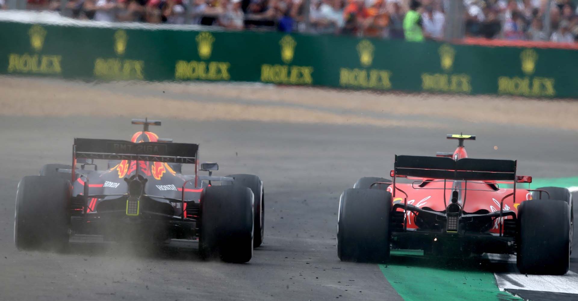 NORTHAMPTON, ENGLAND - JULY 14: Max Verstappen of the Netherlands driving the (33) Aston Martin Red Bull Racing RB15 runs wide as he battles for track position with Charles Leclerc of Monaco driving the (16) Scuderia Ferrari SF90 during the F1 Grand Prix of Great Britain at Silverstone on July 14, 2019 in Northampton, England. (Photo by Charles Coates/Getty Images) // Getty Images / Red Bull Content Pool  // AP-1ZXUVU8QN2111 // Usage for editorial use only // Please go to www.redbullcontentpool.com for further information. //