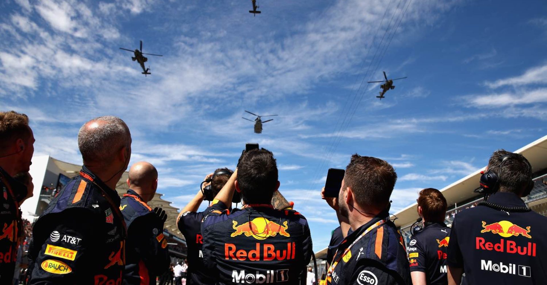 AUSTIN, TX - OCTOBER 21: The Red Bull Racing team look on as four chinooks fly over hthe grid during the United States Formula One Grand Prix at Circuit of The Americas on October 21, 2018 in Austin, United States.  (Photo by Mark Thompson/Getty Images)