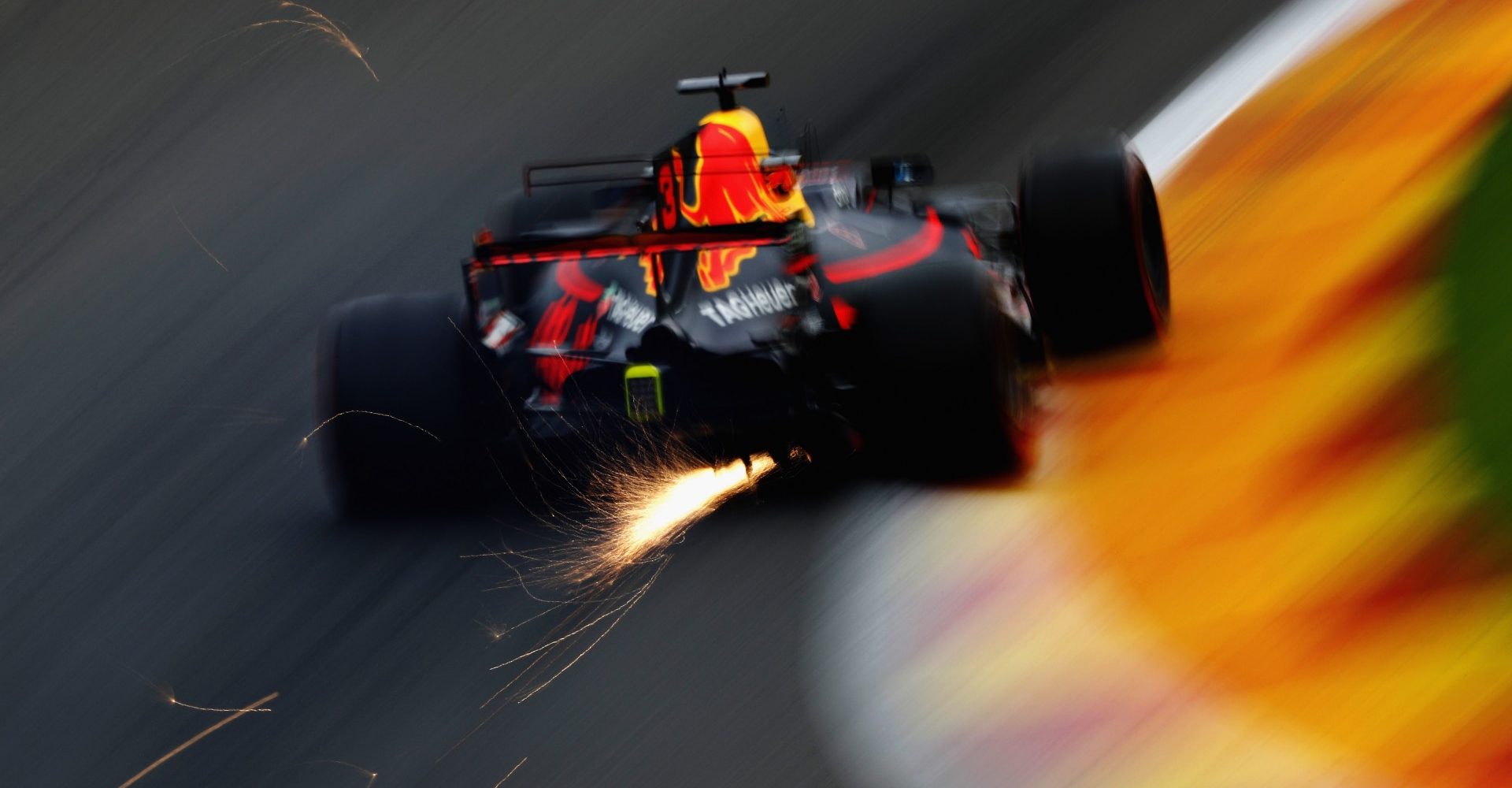 SPA, BELGIUM - AUGUST 25: Sparks fly behind Daniel Ricciardo of Australia driving the (3) Red Bull Racing Red Bull-TAG Heuer RB13 TAG Heuer on track during practice for the Formula One Grand Prix of Belgium at Circuit de Spa-Francorchamps on August 25, 2017 in Spa, Belgium.  (Photo by Mark Thompson/Getty Images)