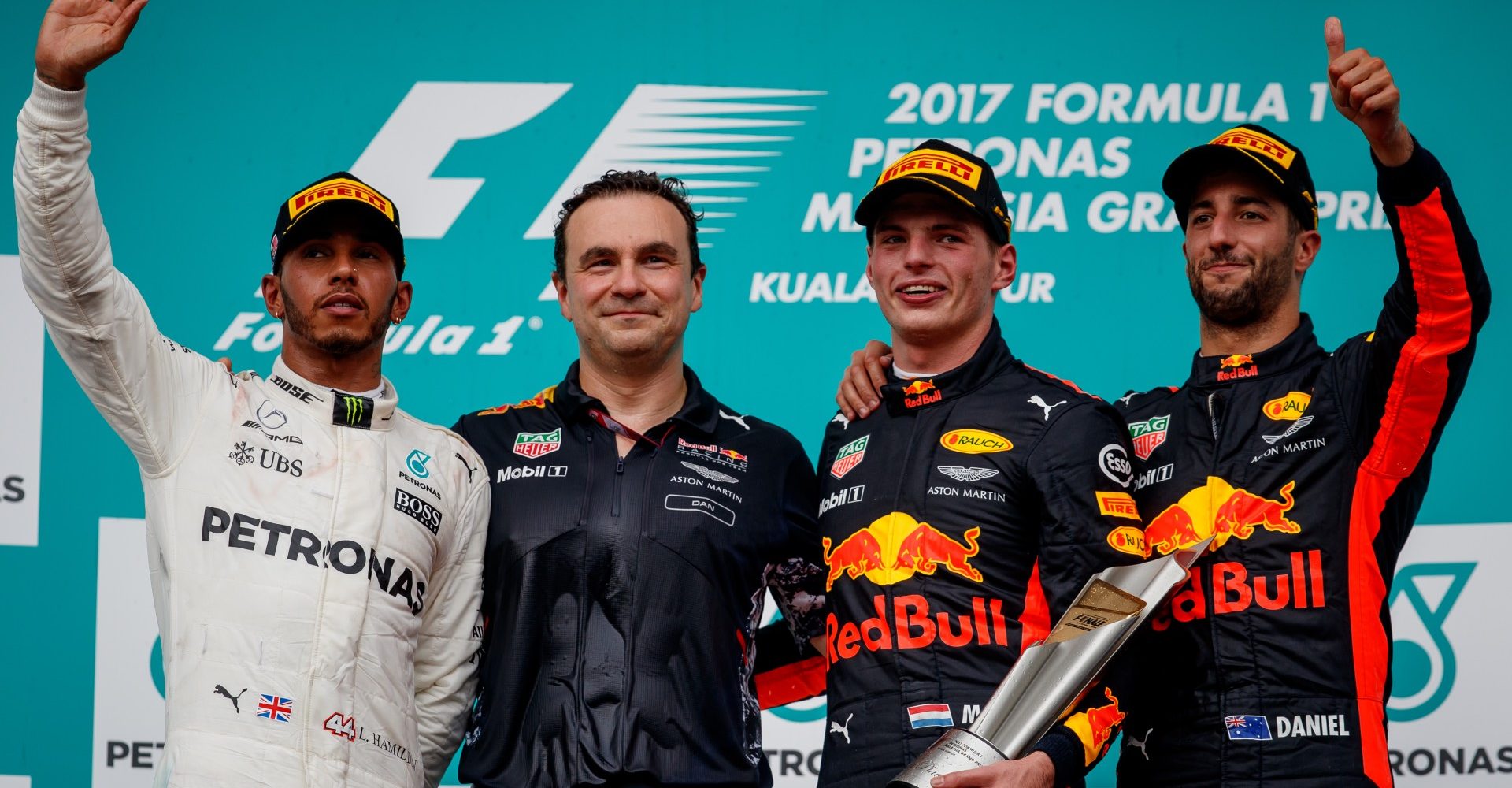 KUALA LUMPUR, MALAYSIA - OCTOBER 01:  Race winner Max Verstappen of Netherlands and Red Bull Racing celebrates with second place finisher Lewis Hamilton of Great Britain and Mercedes GP, third place finisher Daniel Ricciardo of Australia and Red Bull Racing and Dan Fallows, Chief Aerodynamics Engineer of Red Bull Racing on the podium during the Malaysia Formula One Grand Prix at Sepang Circuit on October 1, 2017 in Kuala Lumpur, Malaysia.  (Photo by Lars Baron/Getty Images) MalaysianGP2017