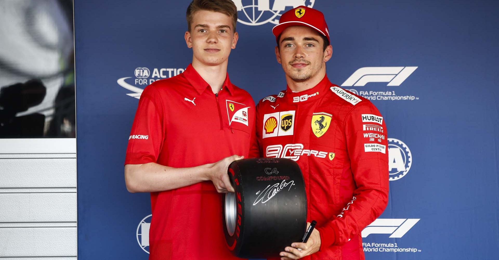 SOCHI AUTODROM, RUSSIAN FEDERATION - SEPTEMBER 28: Charles Leclerc, Ferrari, celebrates pole position, and receives his Pirelli pole trophy from Robert Shwartzman (RUS) PREMA Racing during the Russian GP at Sochi Autodrom on September 28, 2019 in Sochi Autodrom, Russian Federation. (Photo by Andy Hone / LAT Images)