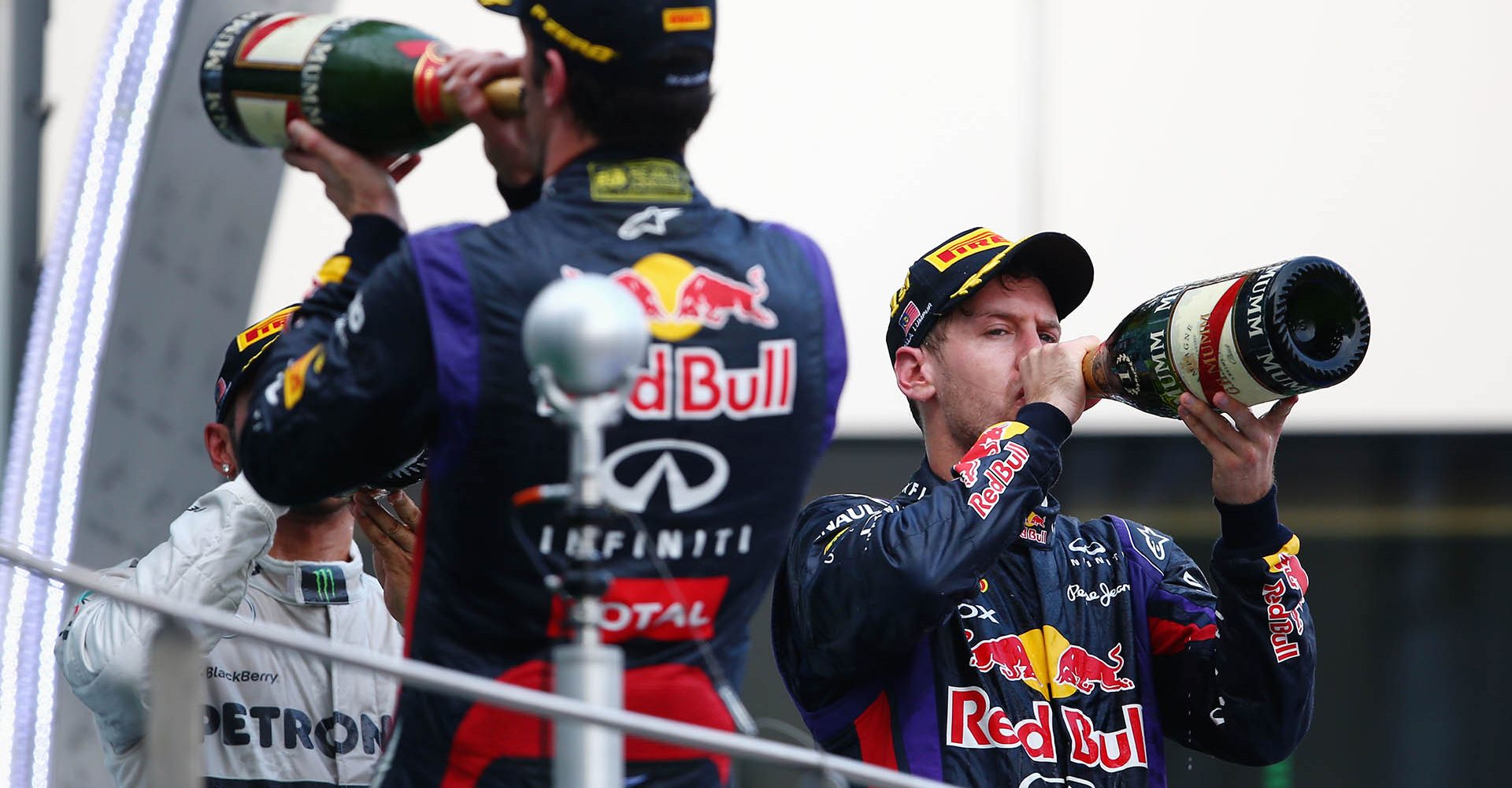 KUALA LUMPUR, MALAYSIA - MARCH 24:  Mark Webber (L) of Australia and Infiniti Red Bull Racing celebrates finishing second alongside race winner Sebastian Vettel of Germany and Infiniti Red Bull Racing on the podium following the Malaysian Formula One Grand Prix at the Sepang Circuit on March 24, 2013 in Kuala Lumpur, Malaysia.  (Photo by Paul Gilham/Getty Images) *** Local Caption *** Sebastian Vettel; Mark Webber // Getty Images / Red Bull Content Pool // SI201412184366 // Usage for editorial use only //