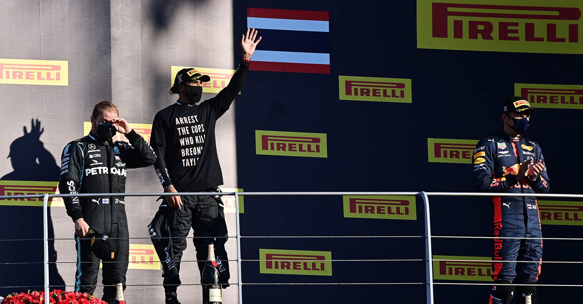 SCARPERIA, ITALY - SEPTEMBER 13: Race winner Lewis Hamilton of Great Britain and Mercedes GP, second placed Valtteri Bottas of Finland and Mercedes GP and third placed Alexander Albon of Thailand and Red Bull Racing celebrate on the podium during the F1 Grand Prix of Tuscany at Mugello Circuit on September 13, 2020 in Scarperia, Italy. (Photo by Miguel Medina - Pool/Getty Images)