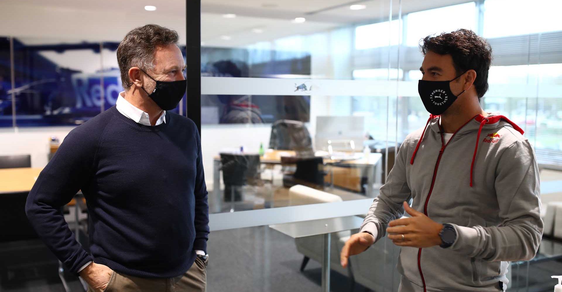 MILTON KEYNES, ENGLAND - JANUARY 11: Sergio Perez of Mexico and Red Bull Racing talks with Red Bull Racing Team Principal Christian Horner at Red Bull Racing Factory on January 11, 2021 in Milton Keynes, England. (Photo by Mark Thompson/Getty Images)