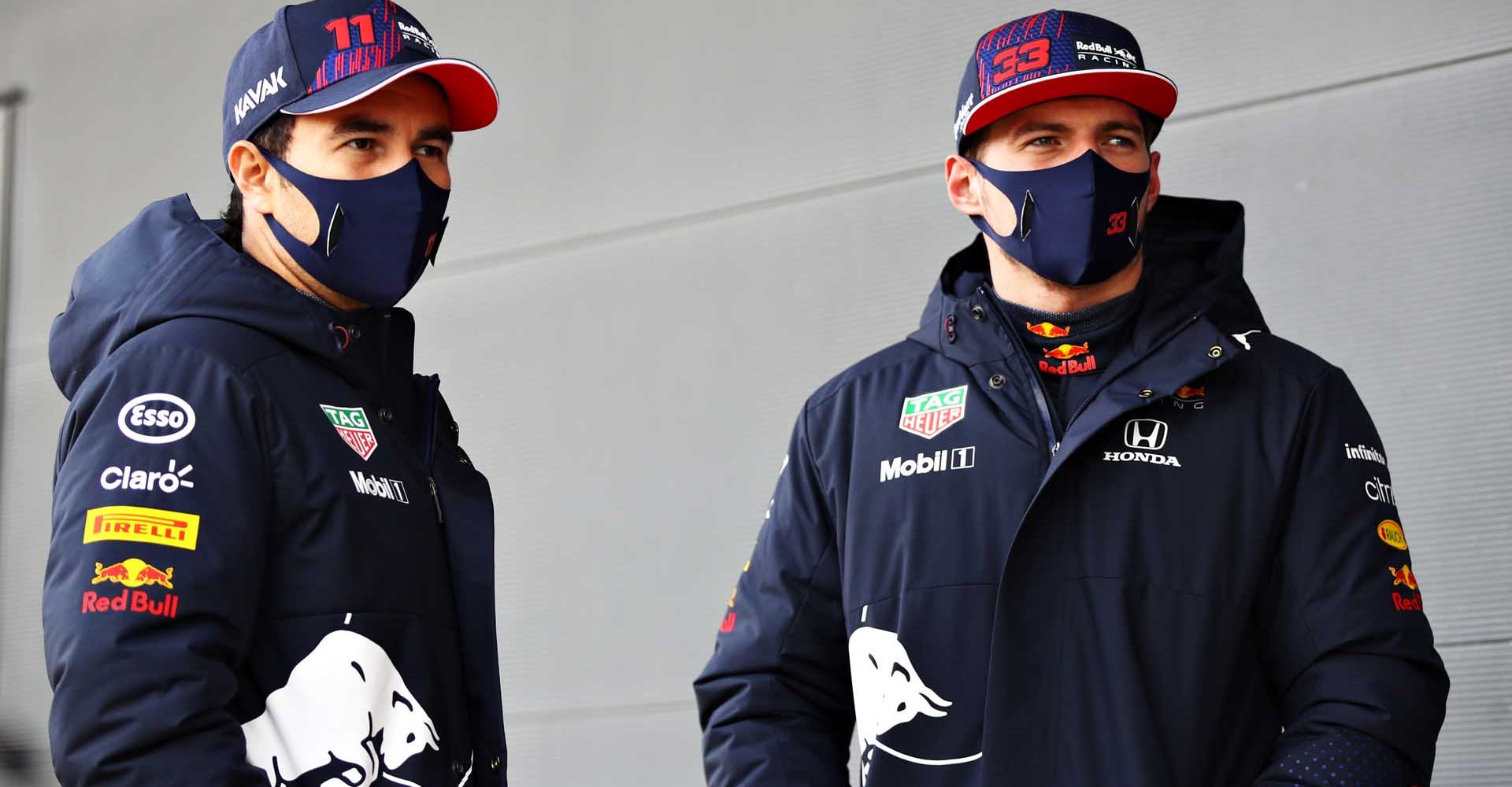 NORTHAMPTON, ENGLAND - FEBRUARY 24: Max Verstappen of Netherlands and Red Bull Racing and Sergio Perez of Mexico and Red Bull Racing talk in the Pitlane during the Red Bull Racing Filming Day at Silverstone on February 24, 2021 in Northampton, England. (Photo by Mark Thompson/Getty Images for Red Bull Racing)