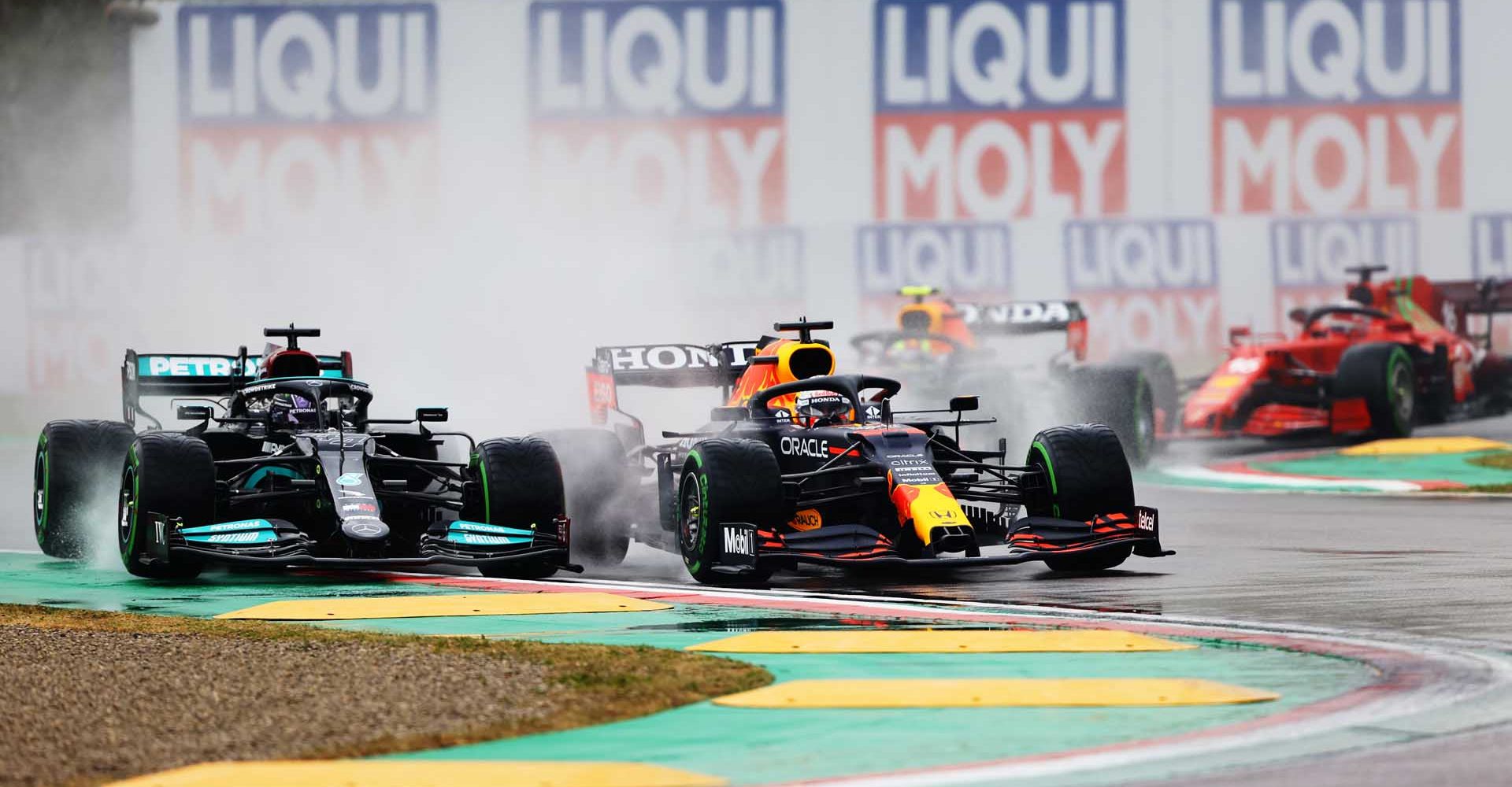 IMOLA, ITALY - APRIL 18: Lewis Hamilton of Great Britain driving the (44) Mercedes AMG Petronas F1 Team Mercedes W12 and Max Verstappen of the Netherlands driving the (33) Red Bull Racing RB16B Honda compete for position on track during the F1 Grand Prix of Emilia Romagna at Autodromo Enzo e Dino Ferrari on April 18, 2021 in Imola, Italy. (Photo by Bryn Lennon/Getty Images)