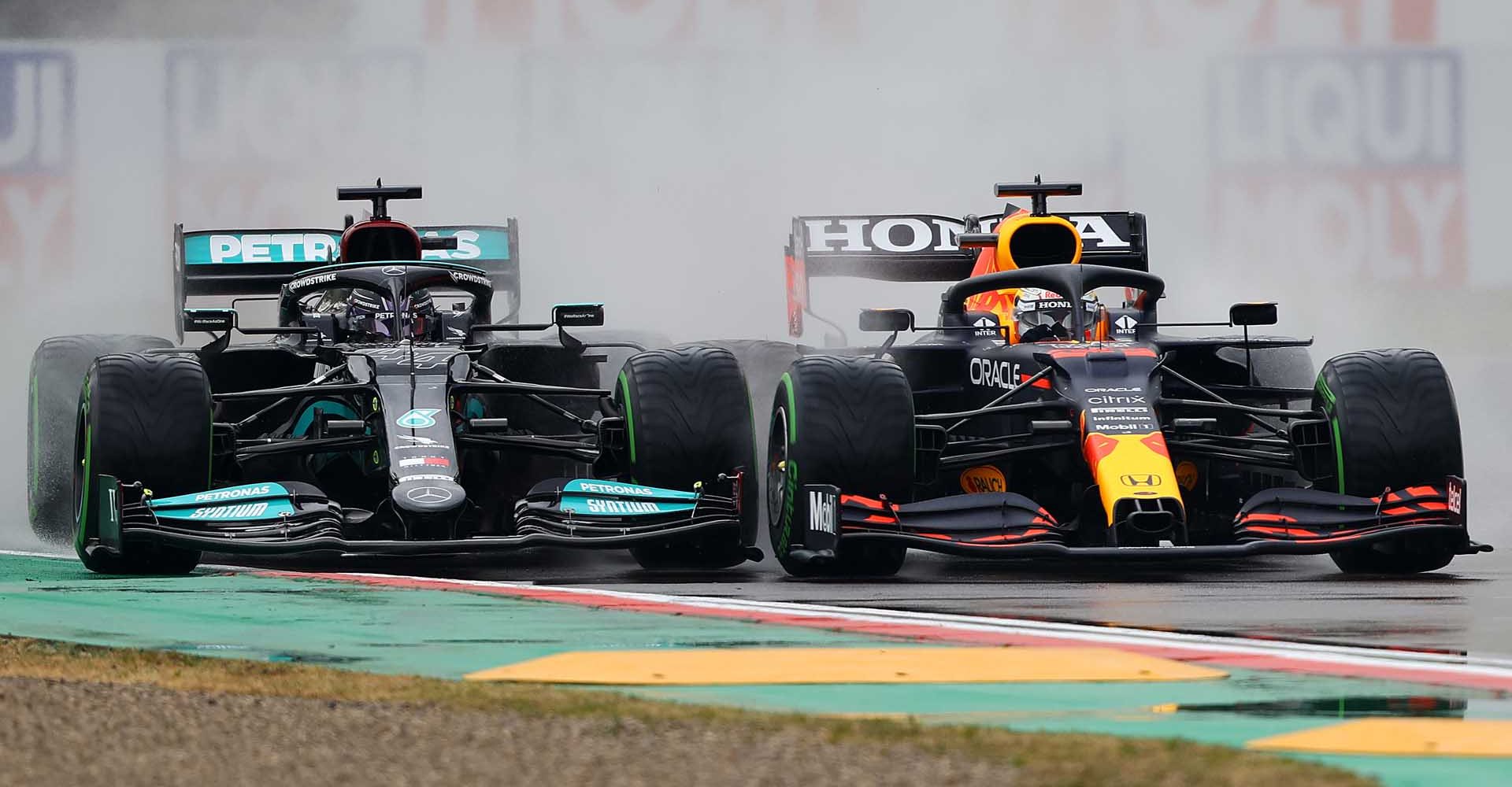 IMOLA, ITALY - APRIL 18: Max Verstappen of the Netherlands driving the (33) Red Bull Racing RB16B Honda and Lewis Hamilton of Great Britain driving the (44) Mercedes AMG Petronas F1 Team Mercedes W12 battle for track position at the start during the F1 Grand Prix of Emilia Romagna at Autodromo Enzo e Dino Ferrari on April 18, 2021 in Imola, Italy. (Photo by Bryn Lennon/Getty Images)