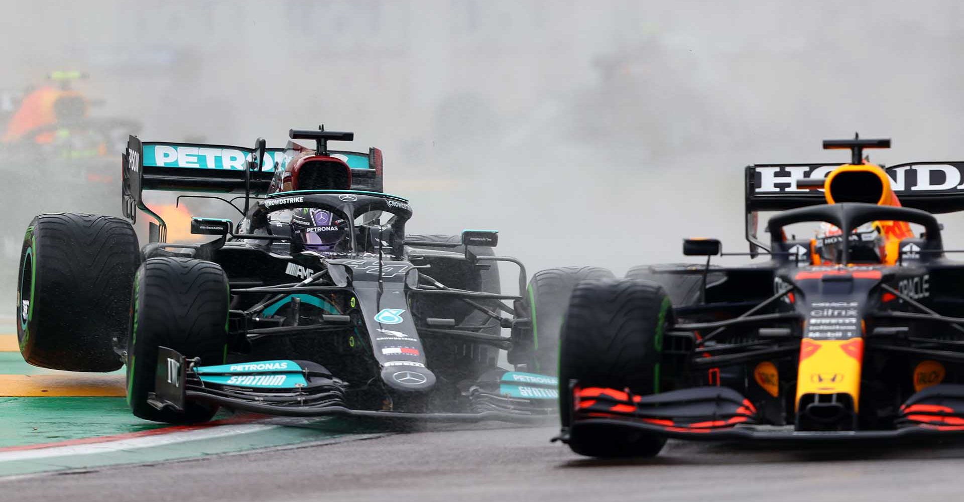 IMOLA, ITALY - APRIL 18: Max Verstappen of the Netherlands driving the (33) Red Bull Racing RB16B Honda and Lewis Hamilton of Great Britain driving the (44) Mercedes AMG Petronas F1 Team Mercedes W12 battle for track position at the start during the F1 Grand Prix of Emilia Romagna at Autodromo Enzo e Dino Ferrari on April 18, 2021 in Imola, Italy. (Photo by Bryn Lennon/Getty Images)