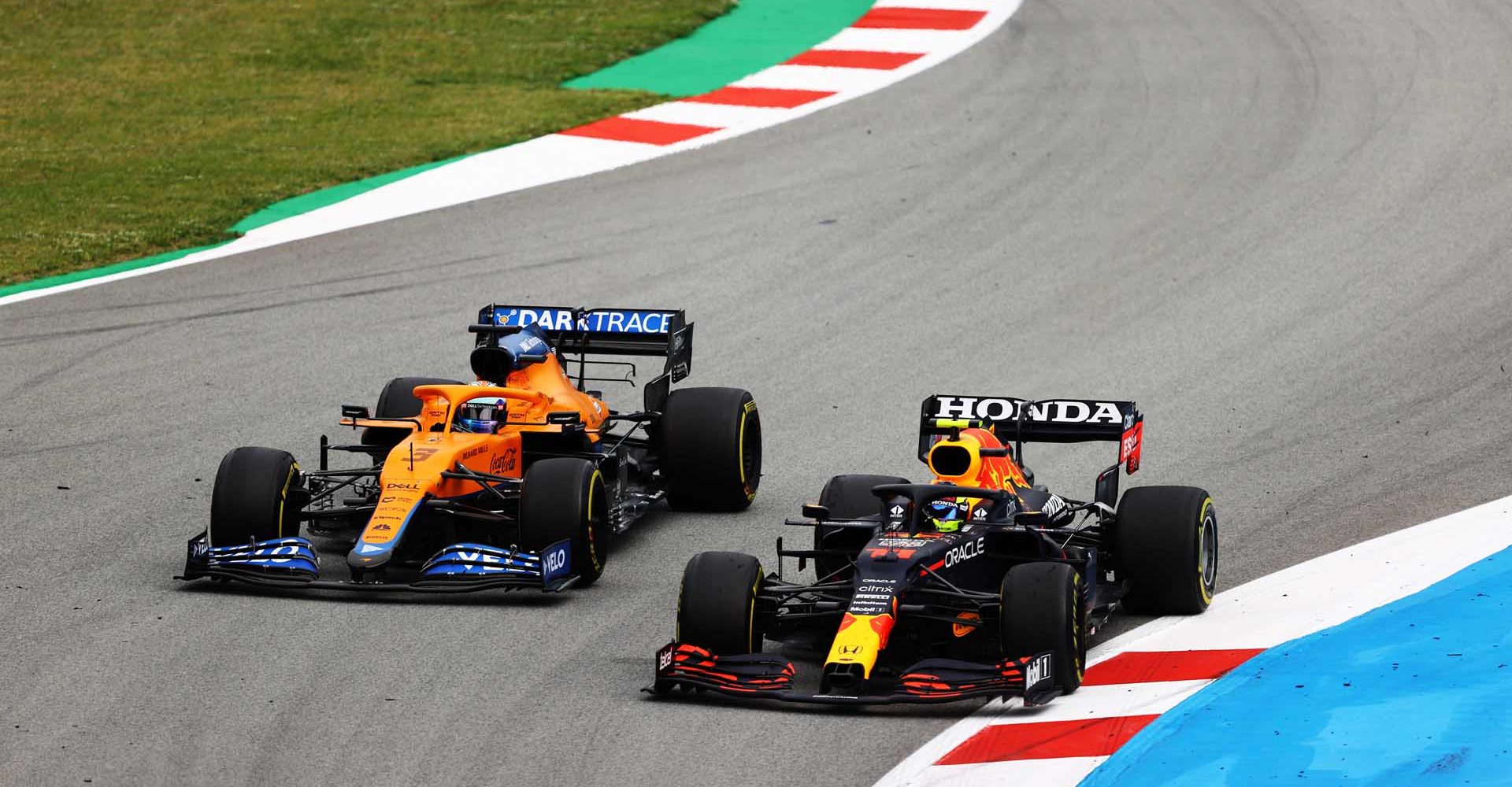 BARCELONA, SPAIN - MAY 09: Daniel Ricciardo of Australia driving the (3) McLaren F1 Team MCL35M Mercedes and Sergio Perez of Mexico driving the (11) Red Bull Racing RB16B Honda on track during the F1 Grand Prix of Spain at Circuit de Barcelona-Catalunya on May 09, 2021 in Barcelona, Spain. (Photo by Bryn Lennon/Getty Images)