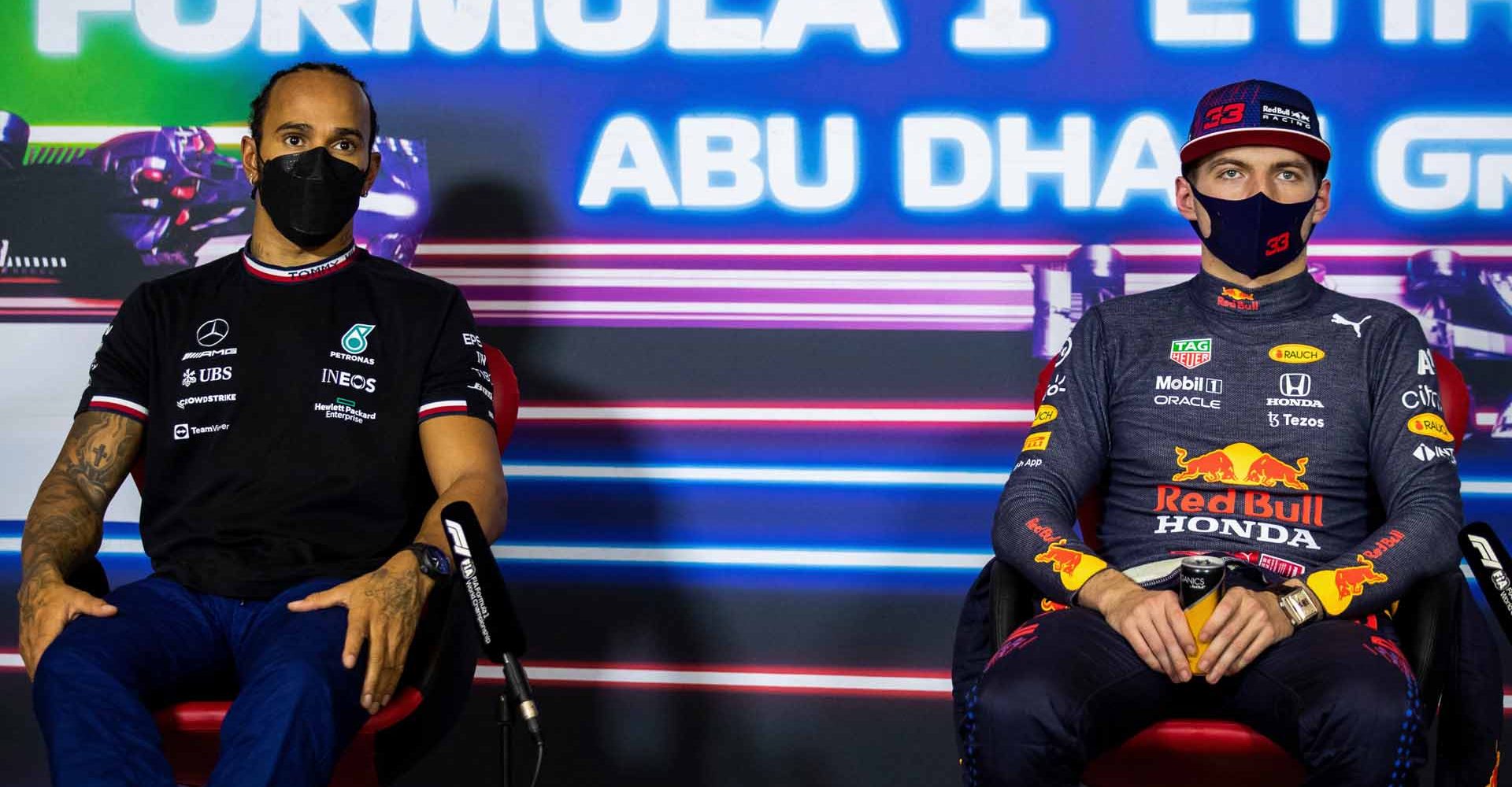 ABU DHABI, UNITED ARAB EMIRATES - DECEMBER 11: Pole position qualifier Max Verstappen of Netherlands and Red Bull Racing and second place qualifier Lewis Hamilton of Great Britain and Mercedes GP talk in the press conference after qualifying ahead of the F1 Grand Prix of Abu Dhabi at Yas Marina Circuit on December 11, 2021 in Abu Dhabi, United Arab Emirates. (Photo by Sam Bloxham - Pool/Getty Images)