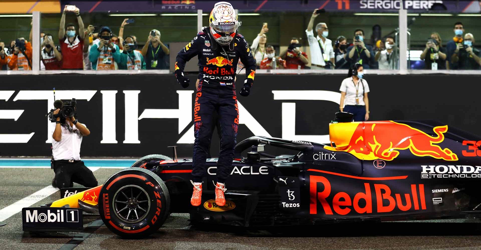 ABU DHABI, UNITED ARAB EMIRATES - DECEMBER 12: Race winner and 2021 F1 World Drivers Champion Max Verstappen of Netherlands and Red Bull Racing celebrates in parc ferme during the F1 Grand Prix of Abu Dhabi at Yas Marina Circuit on December 12, 2021 in Abu Dhabi, United Arab Emirates. (Photo by Bryn Lennon/Getty Images)