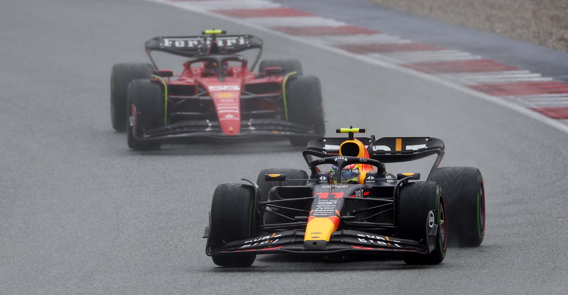 SPIELBERG, AUSTRIA - JULY 01: Sergio Perez of Mexico driving the (11) Oracle Red Bull Racing RB19 leads Carlos Sainz of Spain driving (55) the Ferrari SF-23 on track during the Sprint ahead of the F1 Grand Prix of Austria at Red Bull Ring on July 01, 2023 in Spielberg, Austria. (Photo by Lars Baron/Getty Images)