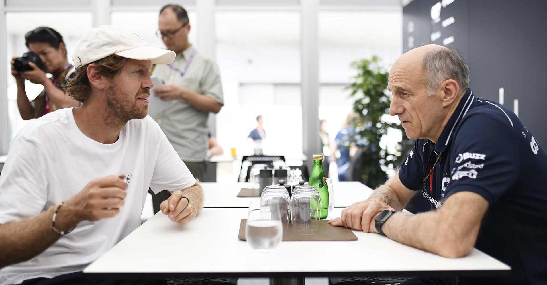 SUZUKA, JAPAN - SEPTEMBER 21: Scuderia AlphaTauri Team Principal Franz Tost talks with Sebastian Vettel in the Paddock during previews ahead of the F1 Grand Prix of Japan at Suzuka International Racing Course on September 21, 2023 in Suzuka, Japan. (Photo by Rudy Carezzevoli/Getty Images)