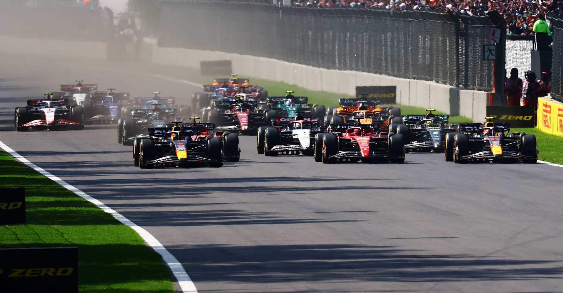 MEXICO CITY, MEXICO - OCTOBER 29: Max Verstappen of the Netherlands driving the (1) Oracle Red Bull Racing RB19, Charles Leclerc of Monaco driving the (16) Ferrari SF-23 and Sergio Perez of Mexico driving the (11) Oracle Red Bull Racing RB19 compete for track position into the first corner at the start of the race during the F1 Grand Prix of Mexico at Autodromo Hermanos Rodriguez on October 29, 2023 in Mexico City, Mexico. (Photo by Mark Thompson/Getty Images) // Getty Images / Red Bull Content Pool // SI202310290553 // Usage for editorial use only //