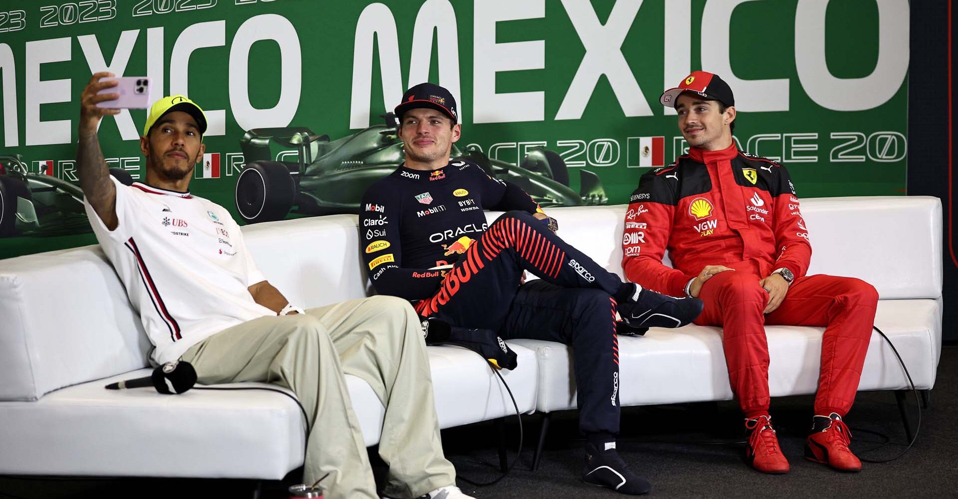 MEXICO CITY, MEXICO - OCTOBER 29: Second placed Lewis Hamilton of Great Britain and Mercedes talks a photo with Race winner Max Verstappen of the Netherlands and Oracle Red Bull Racing and Third placed Charles Leclerc of Monaco and Ferrari as they attend a press conference after the F1 Grand Prix of Mexico at Autodromo Hermanos Rodriguez on October 29, 2023 in Mexico City, Mexico. (Photo by Jared C. Tilton/Getty Images) // Getty Images / Red Bull Content Pool // SI202310300027 // Usage for editorial use only //