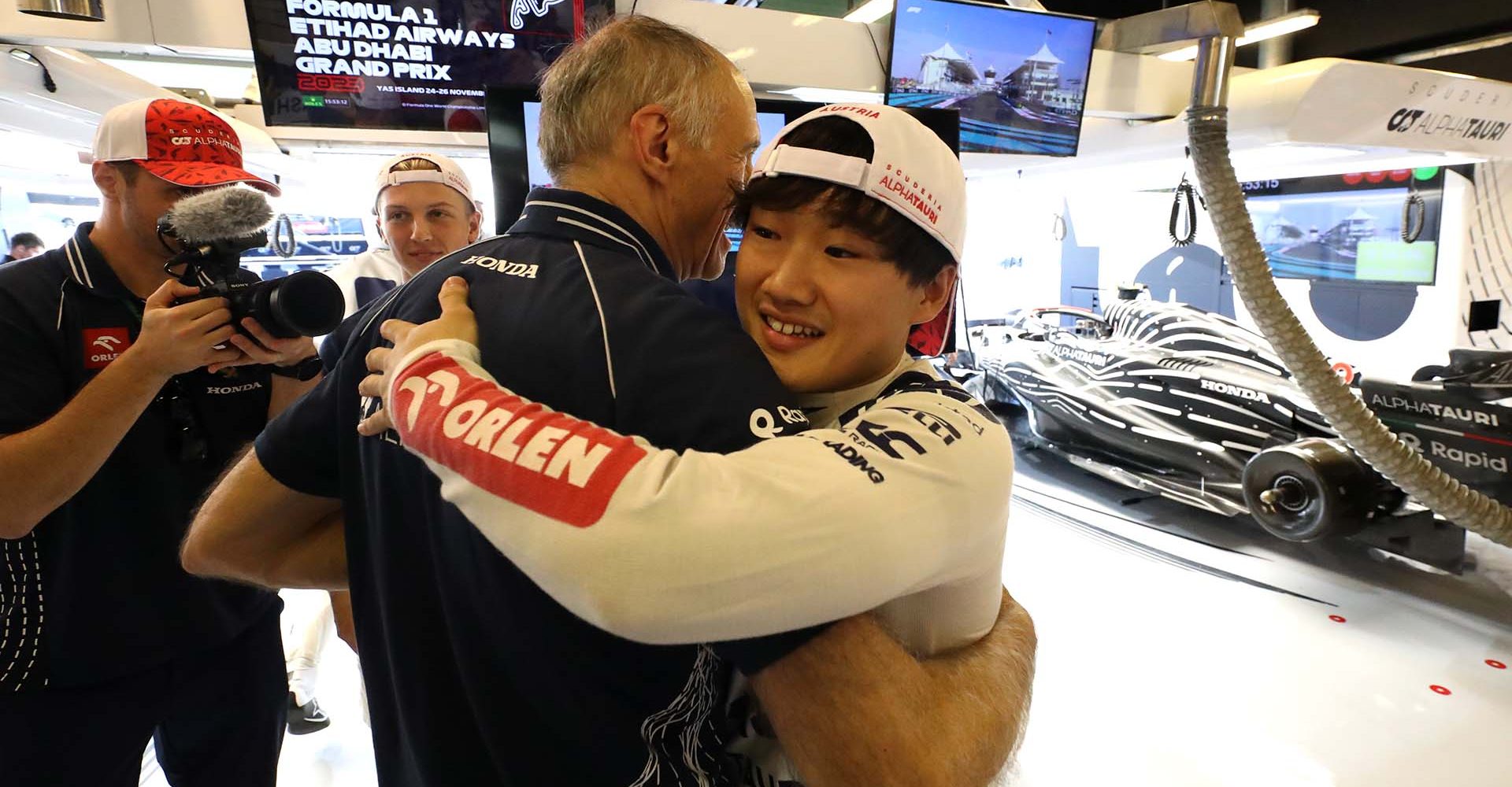 ABU DHABI, UNITED ARAB EMIRATES - NOVEMBER 26: Scuderia AlphaTauri Team Principal Franz Tost is hugged by Yuki Tsunoda of Japan and Scuderia AlphaTauri ahead of his final race prior to the F1 Grand Prix of Abu Dhabi at Yas Marina Circuit on November 26, 2023 in Abu Dhabi, United Arab Emirates. (Photo by Peter Fox/Getty Images)