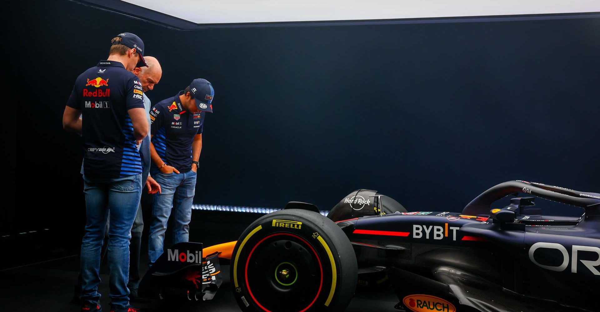 MILTON KEYNES, ENGLAND - FEBRUARY 15: Max Verstappen of the Netherlands and Oracle Red Bull Racing and Sergio Perez of Mexico and Oracle Red Bull Racing look at the RB20 with Adrian Newey, the Chief Technical Officer of Red Bull Racing during the Oracle Red Bull Racing RB20 car launch at Red Bull Racing Factory on February 15, 2024 in Milton Keynes, England. (Photo by Mark Thompson/Getty Images for Red Bull Racing) // SI202402150759 // Usage for editorial use only //