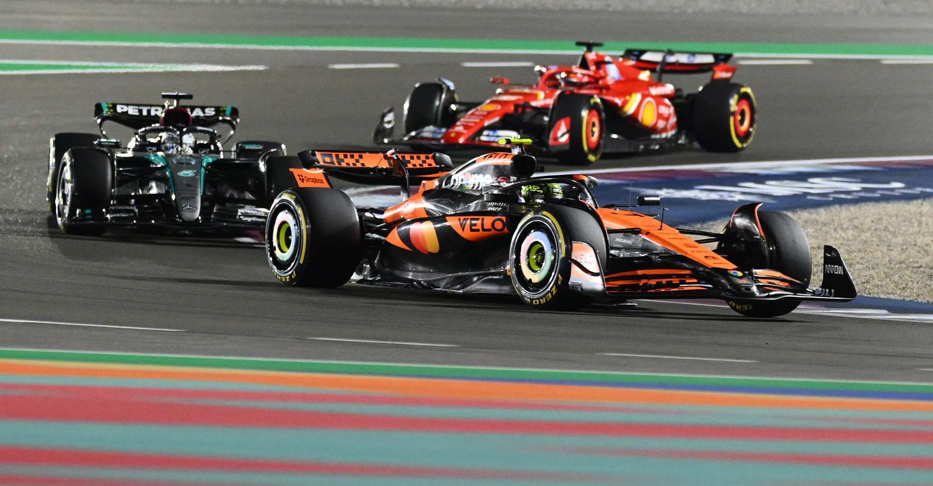 LUSAIL CITY, QATAR - DECEMBER 01: Max Verstappen of the Netherlands driving the (1) Oracle Red Bull Racing RB20 leads Lando Norris of Great Britain driving the (4) McLaren MCL38 Mercedes and George Russell of Great Britain driving the (63) Mercedes AMG Petronas F1 Team W15 during the F1 Grand Prix of Qatar at Lusail International Circuit on December 01, 2024 in Lusail City, Qatar. (Photo by Clive Mason/Getty Images) // Getty Images / Red Bull Content Pool // SI202412010188 // Usage for editorial use only //