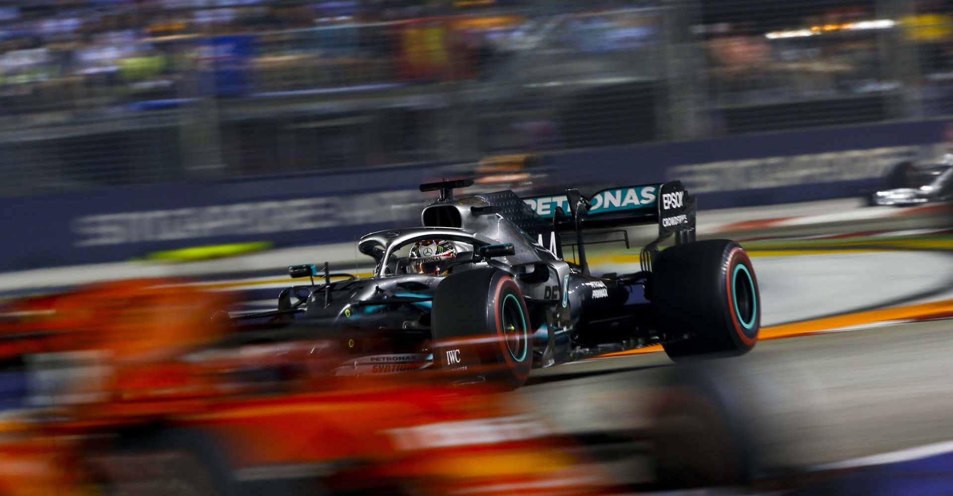 SINGAPORE STREET CIRCUIT, SINGAPORE - SEPTEMBER 22: Lewis Hamilton, Mercedes AMG F1 W10 chases Charles Leclerc, Ferrari SF90 during the Singapore GP at Singapore Street Circuit on September 22, 2019 in Singapore Street Circuit, Singapore. (Photo by Andy Hone / LAT Images)