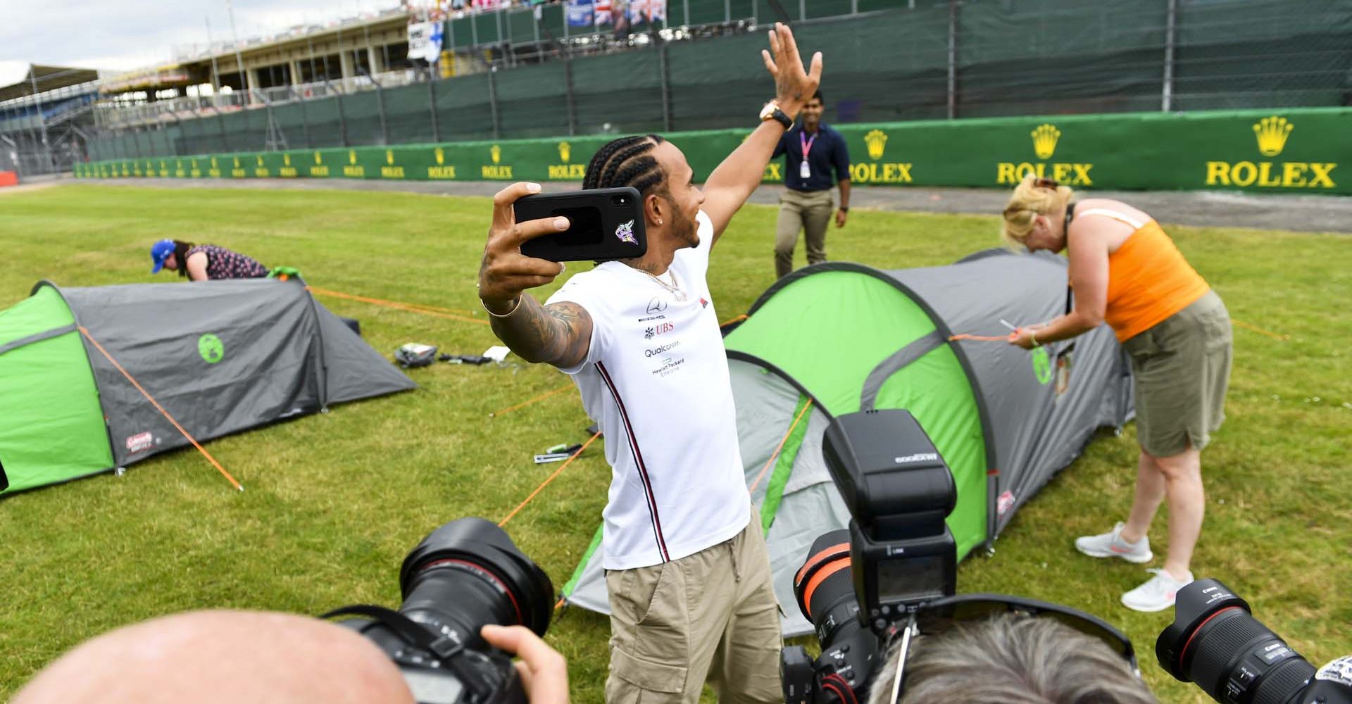 SILVERSTONE, UNITED KINGDOM - JULY 11: Lewis Hamilton, Mercedes AMG F1 takes a selfie with a grandstand full of fans during the British GP at Silverstone on July 11, 2019 in Silverstone, United Kingdom. (Photo by Mark Sutton / LAT Images)